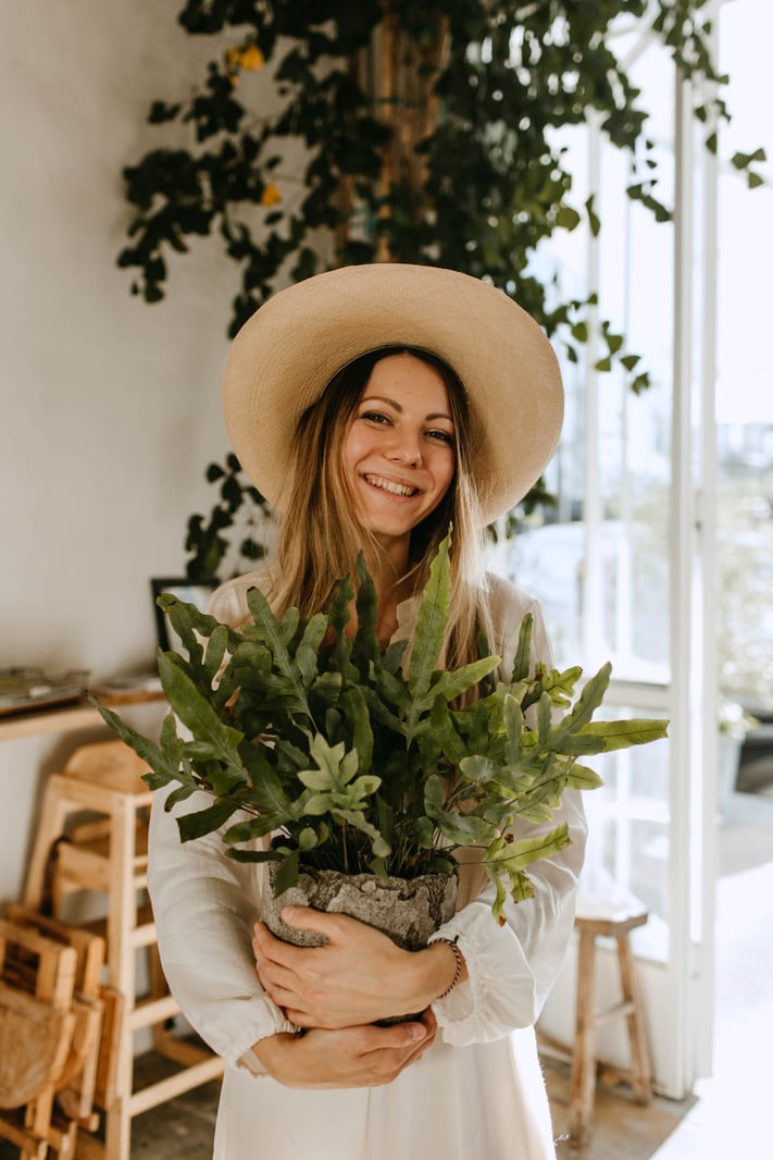 Photo of Woman Carrying Plants